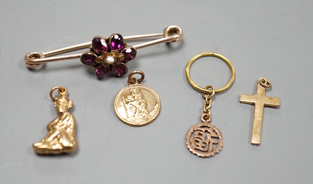 An early 20th century yellow metal, garnet and seed pearl cluster set bar brooch (converted ring?), 44mm and four assorted charms including three 9ct, gross weight 7 grams.